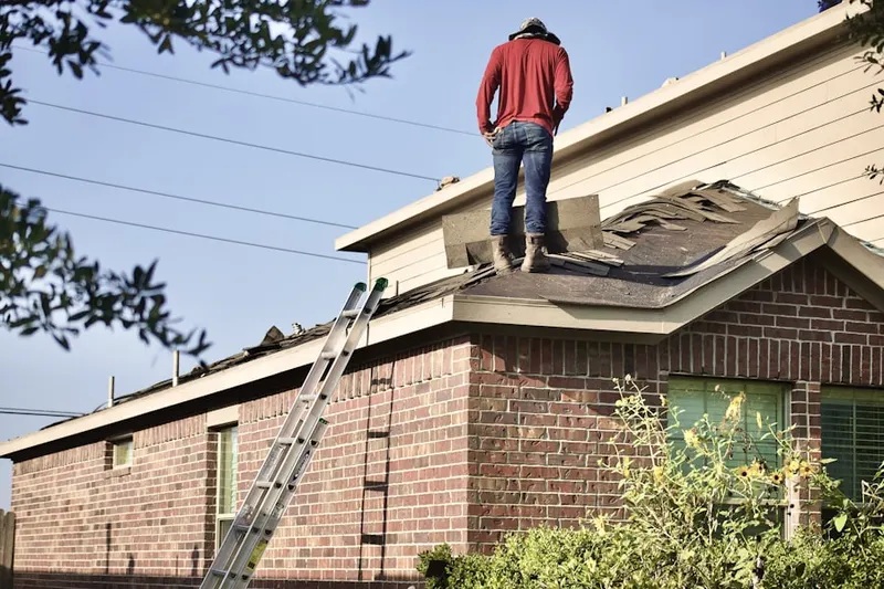 Professional roofer working on a residential roof in Adams Park